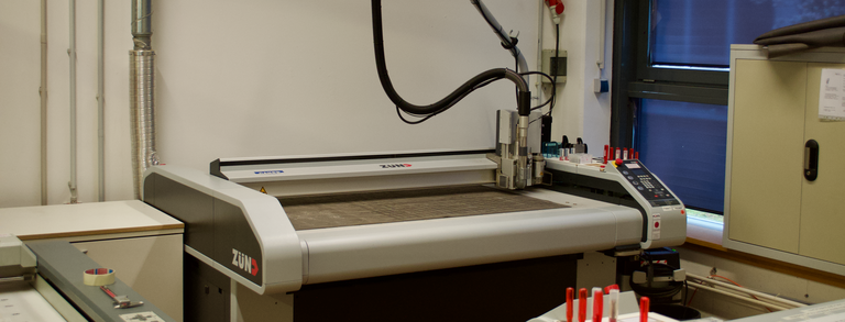 Zu sehen ist ein Zünd M-800 Schneidplotter, dieser wird genutzt um Materialen zu cutten und zu fräsen. 